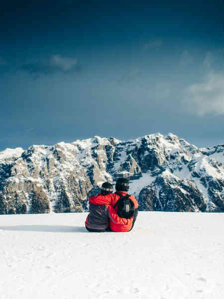 a couple in the snow on a mountain