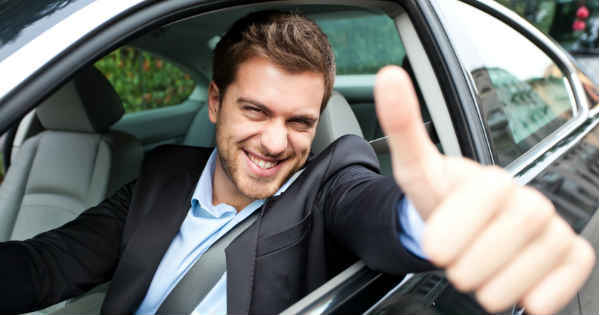 man holding thumbs up from the car