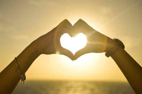 woman making heart shape with hands