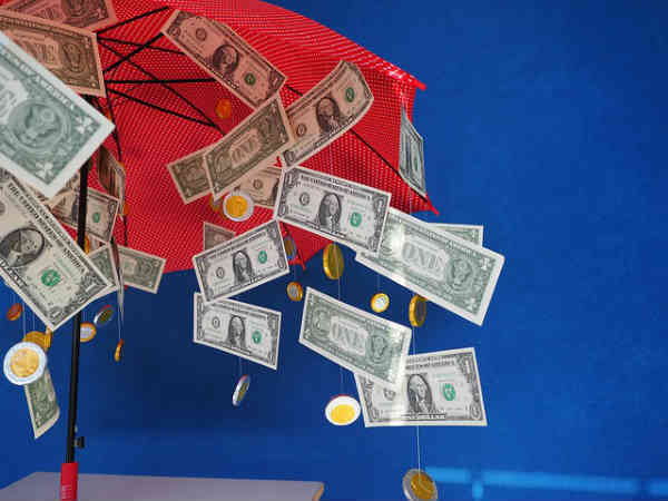 money raining in umbrella