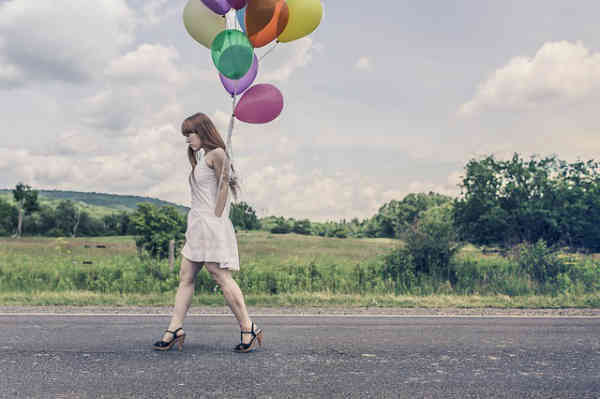 woman walking her talk with baloons