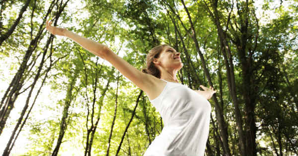 woman with her arms up high