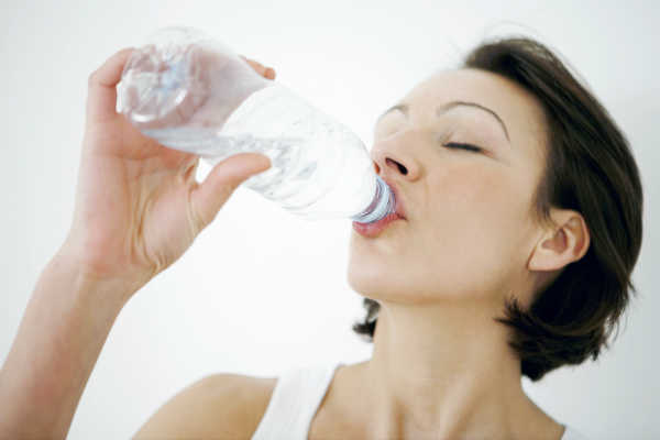 woman drinking bottled water