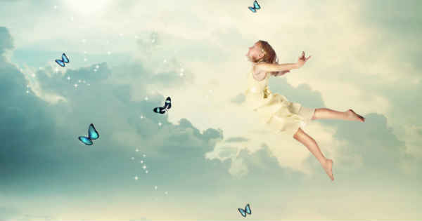woman flying on clouds letting go