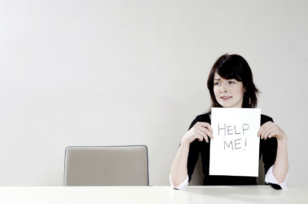 woman hates her job and holds a 'help me' sign