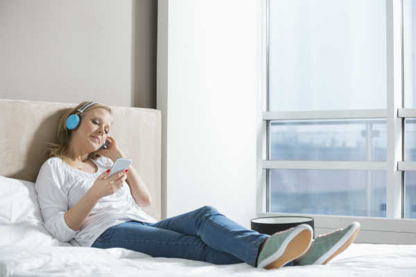 woman wakes up listens to music