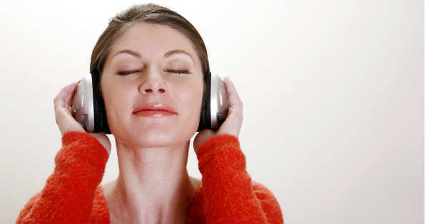 woman enjoying listening to guided meditation on headphones