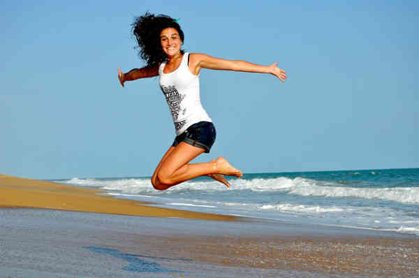 woman jumping on beach