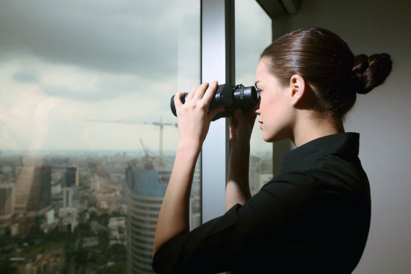 woman looking through binoculars