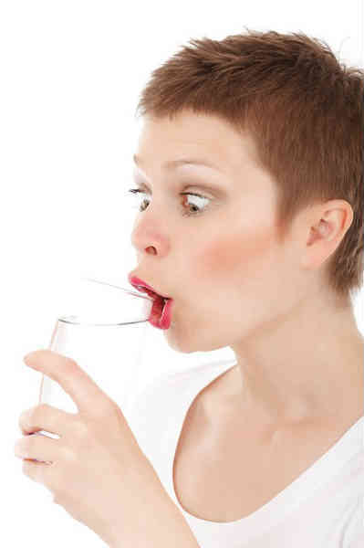 woman enjoying a glass of water