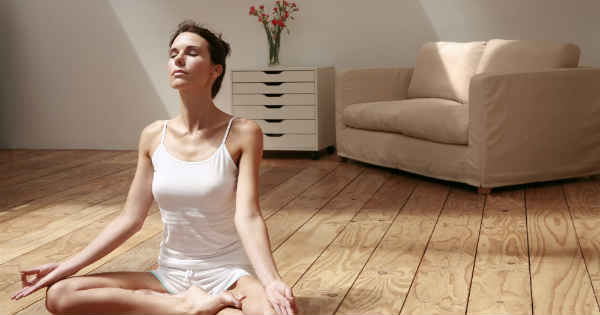 woman meditating in her home