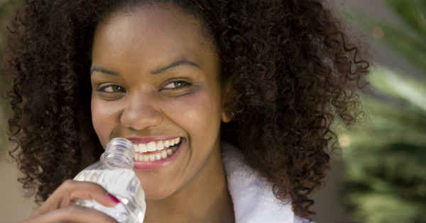 smiling woman rejuvenating herself with water