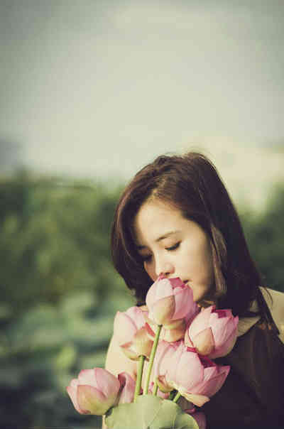 woman smelling flowers