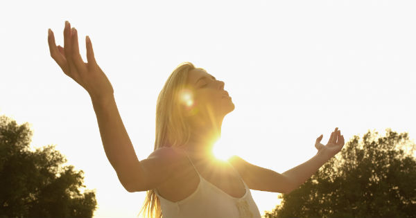 woman with arms up to sun