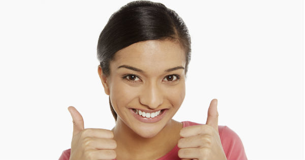 a woman holding her thumbs up