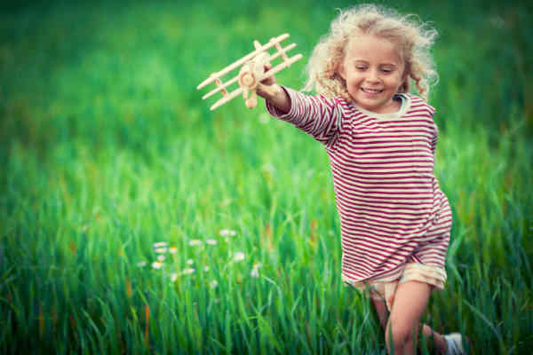 child playing with toy airplane